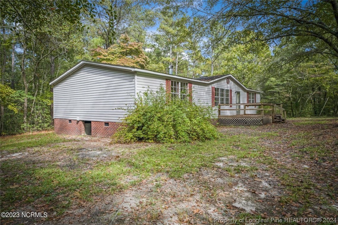 2352 County Line Road Cameron, NC 28326 - Photo 4 of 38 a view of a house with yard and a garden