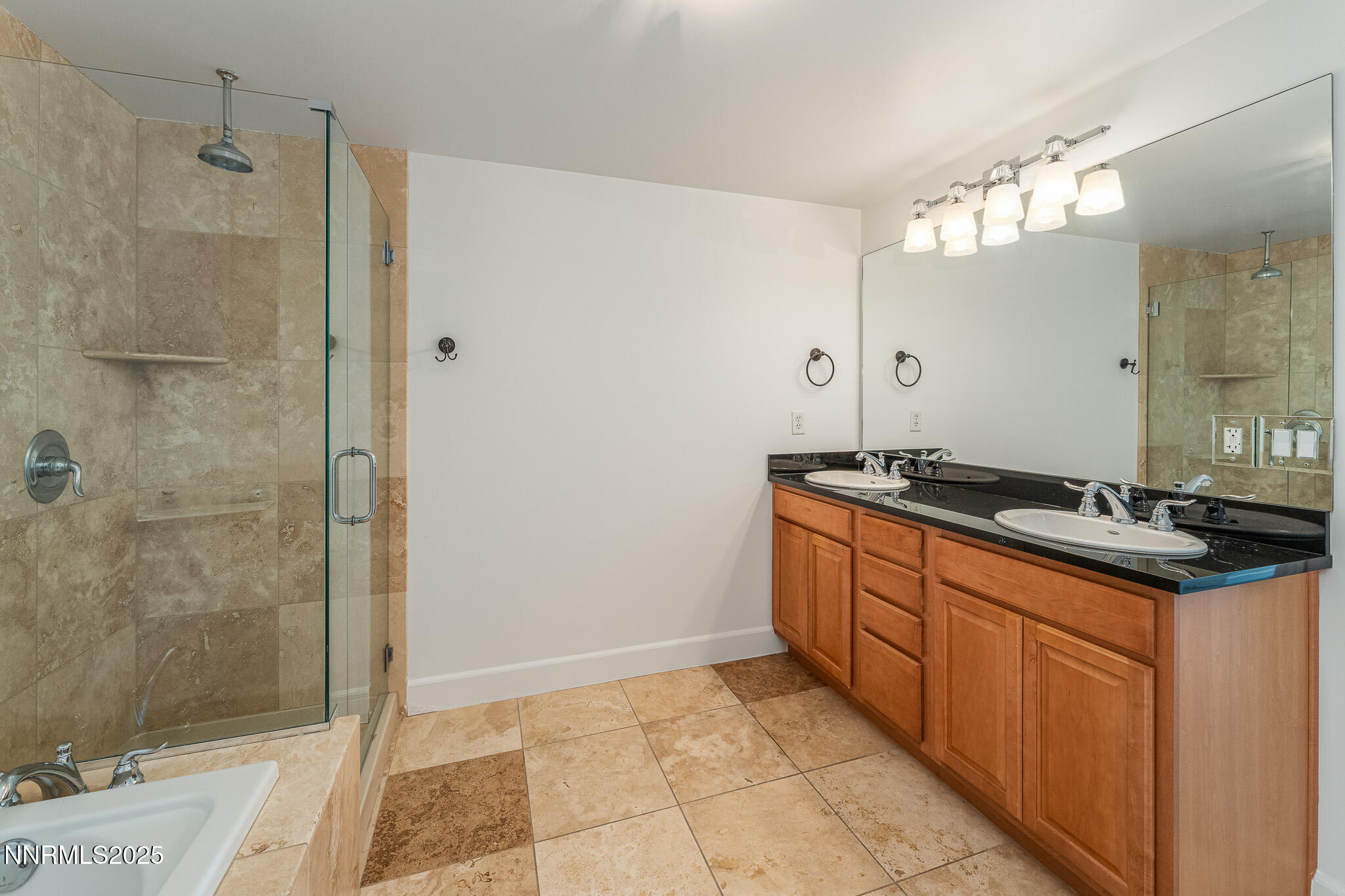 50 North Sierra Street, Unit STE 909 Reno, NV 89501 - Photo 23 of 34 a spacious bathroom with a granite countertop sink a mirror and a shower