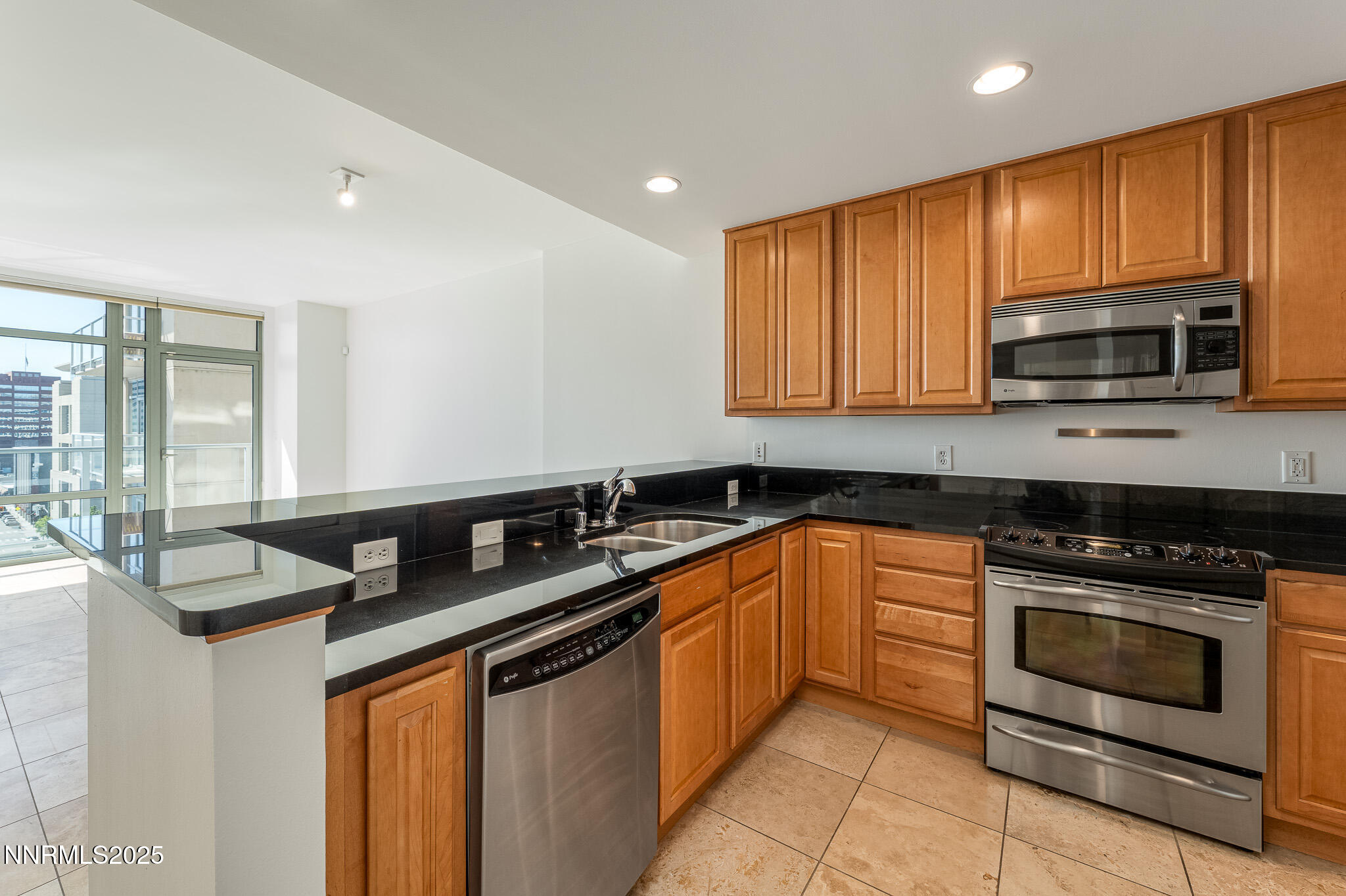50 North Sierra Street, Unit STE 909 Reno, NV 89501 - Photo 3 of 34 a kitchen with stainless steel appliances granite countertop a sink stove microwave and cabinets