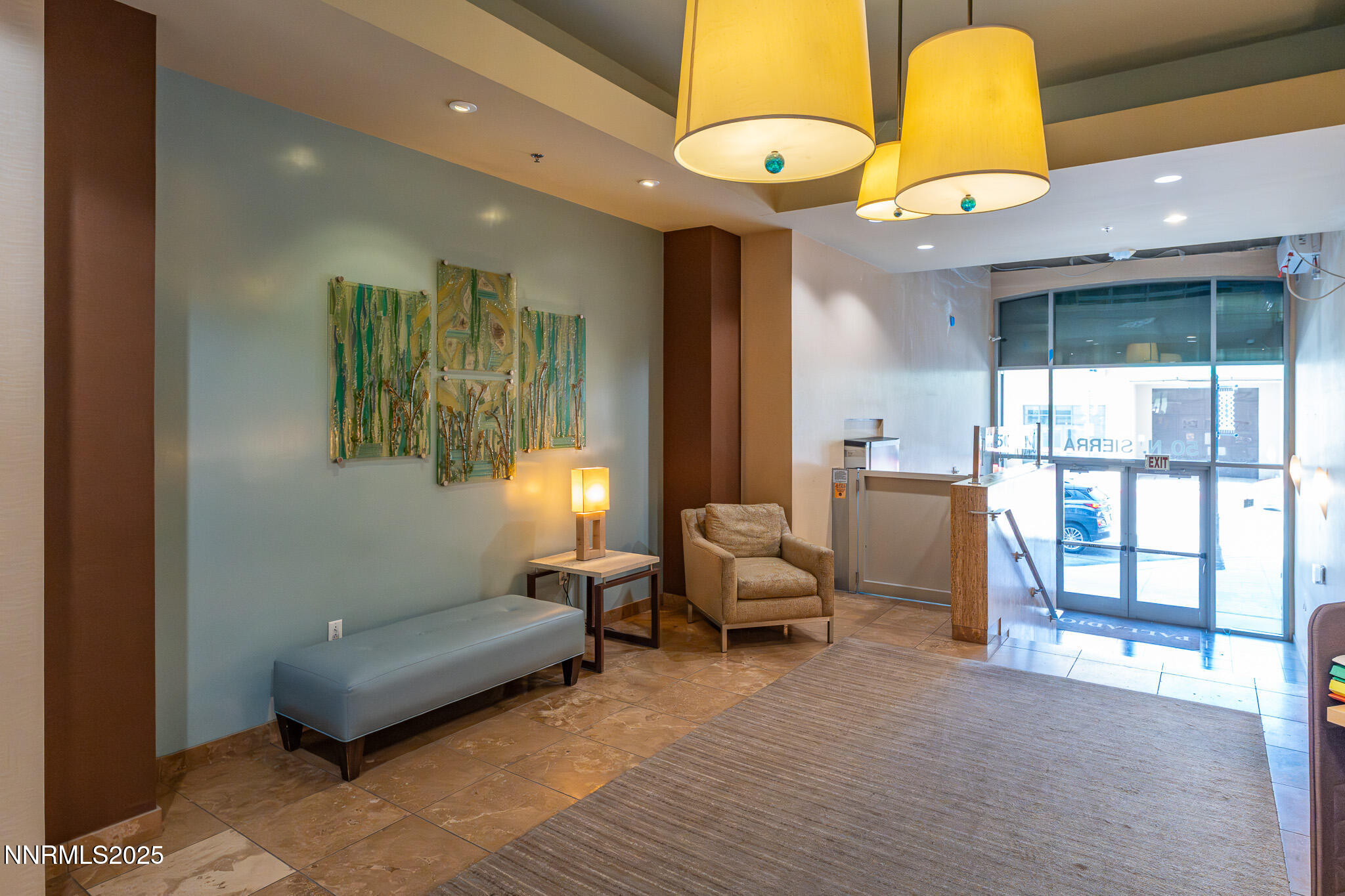 50 North Sierra Street, Unit STE 909 Reno, NV 89501 - Photo 33 of 34 a living room with furniture and a chandelier