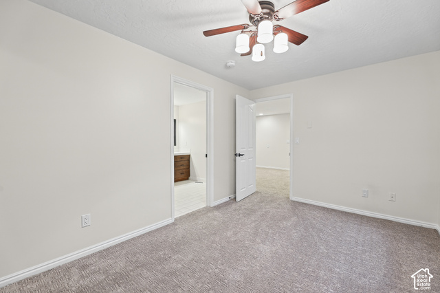 10664 Trail Ridge Circle Sandy, UT 84092 - Photo 47 of 113 Neutral wall paint, textured carpet flooring, ceiling fan with integrated lighting, white trim, and a wood-finish vanity with a white countertop