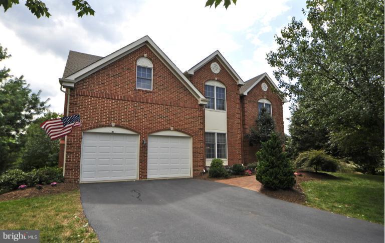 1338 Dasher Lane Reston, VA 20190 - Photo 23 of 24 a front view of a house with a yard and garage