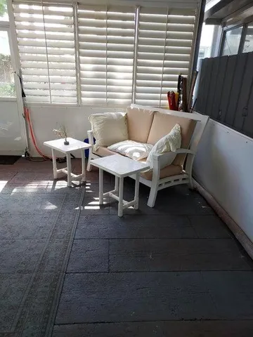 a view of a patio with table and chairs with wooden floor and fence