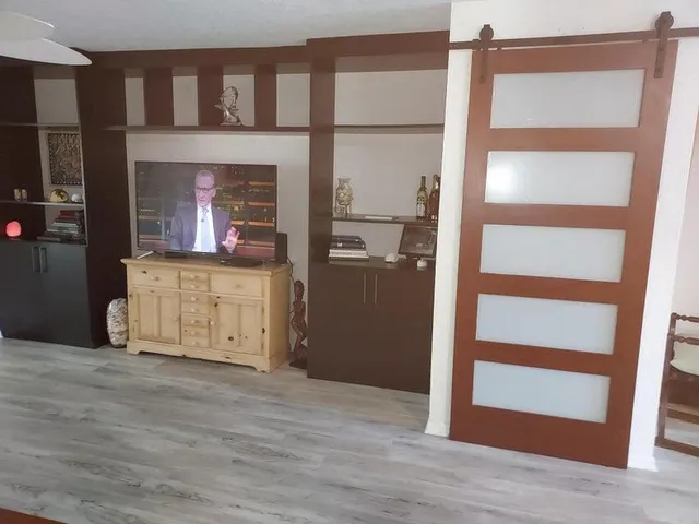 a view of a kitchen with wooden floor and a cabinet