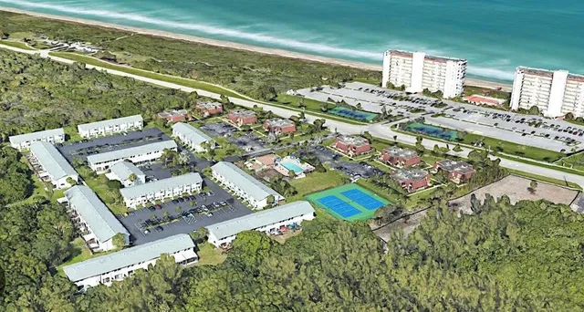 an aerial view of residential houses with outdoor space