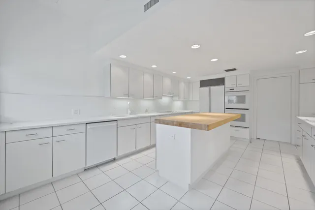 a view of a dining room with a table and chairs
