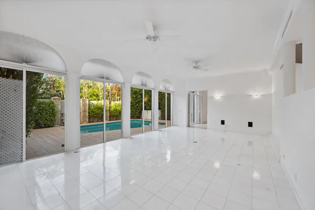 a living room with furniture chandelier and large windows