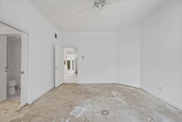 an empty room with a empty space and windows