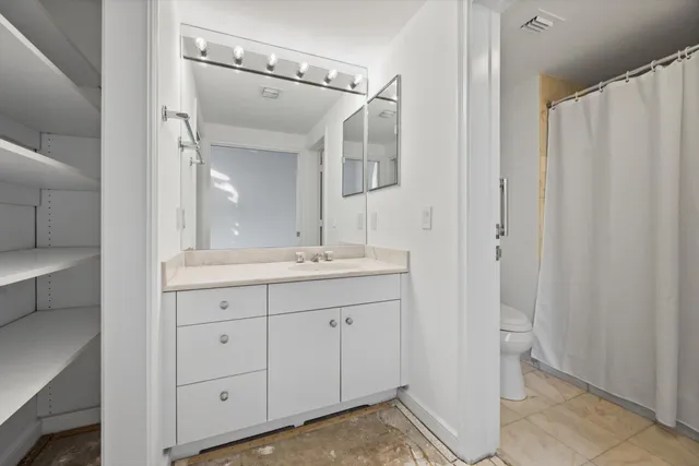 a kitchen with granite countertop a sink and cabinets