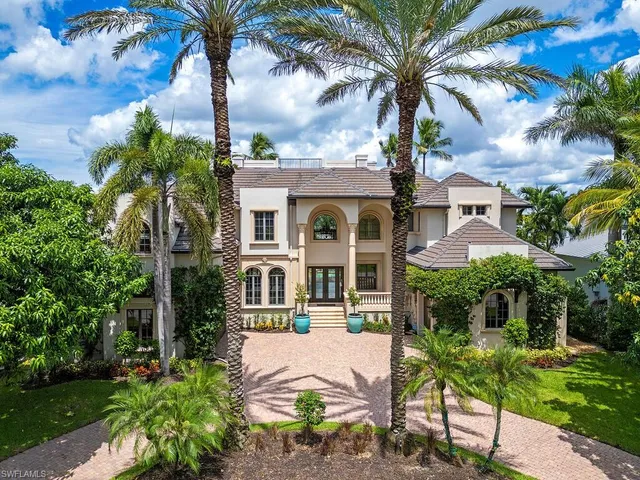 a front view of a house with yard and green space