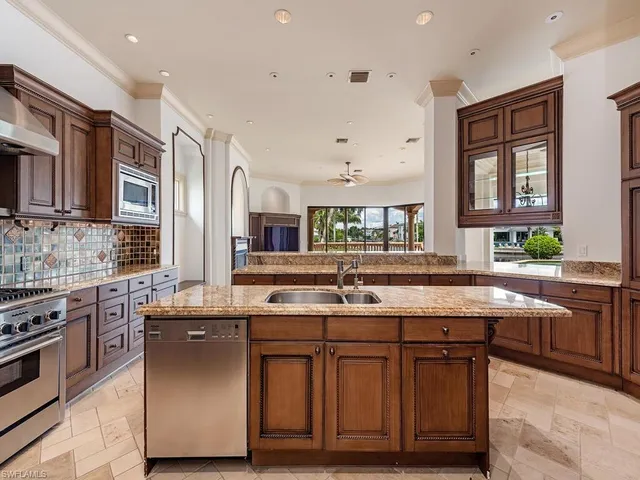 a kitchen with granite countertop a sink stove and cabinets
