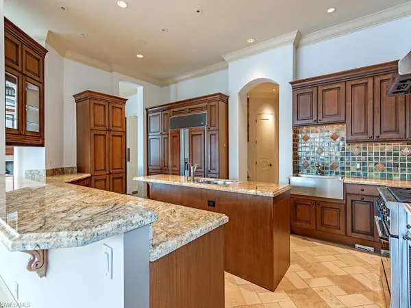 a kitchen with granite countertop a stove and a sink