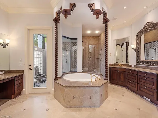 a spacious bathroom with a tub sink a toilet a mirror and shower
