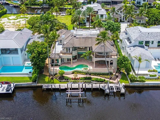 an aerial view of a house with swimming pool patio and outdoor seating
