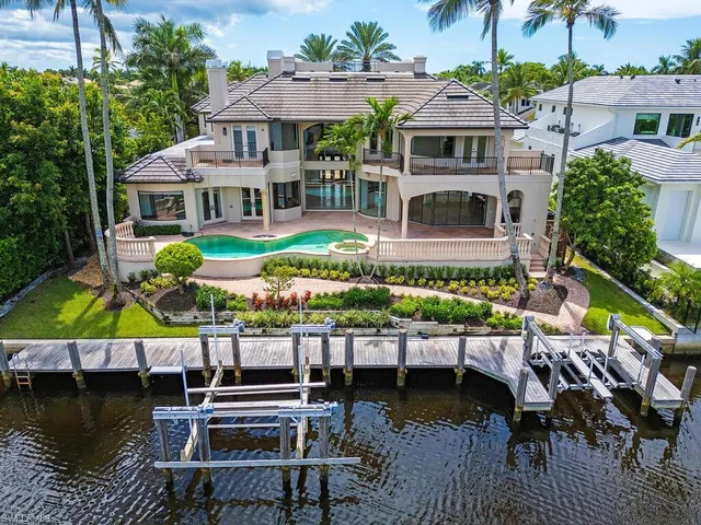an aerial view of a house with swimming pool having outdoor seating
