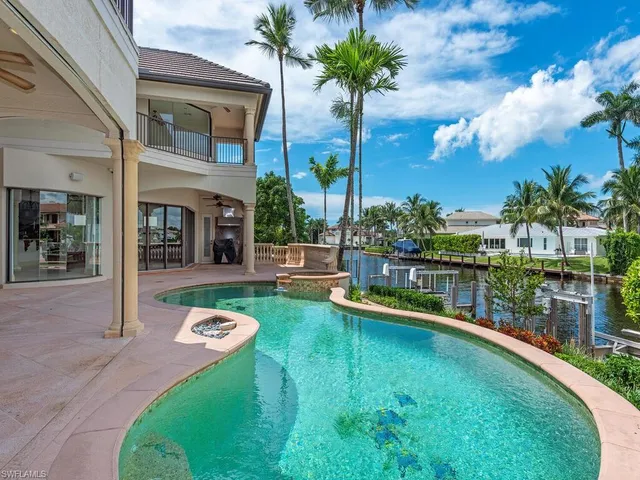 a swimming pool with outdoor seating and yard