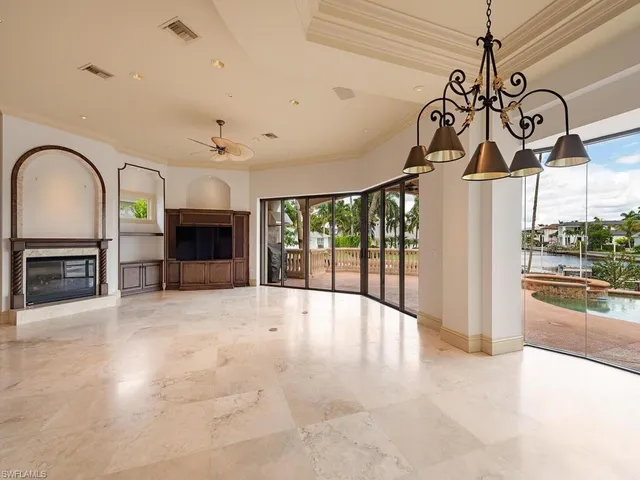 a view of an entryway with a fireplace and a chandelier