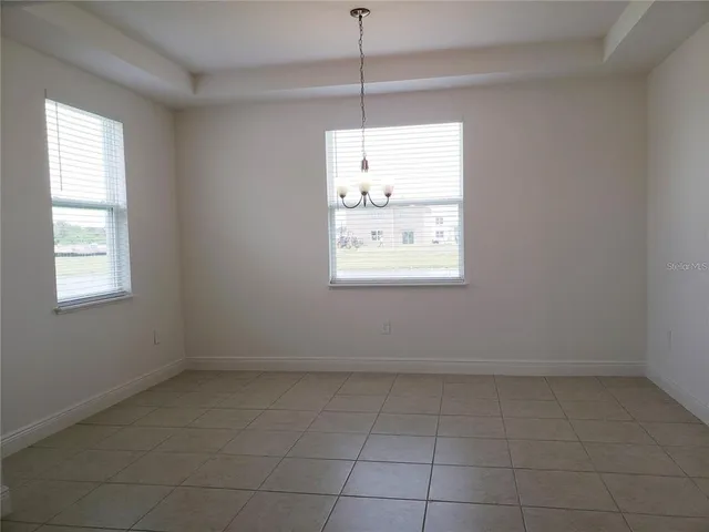 a large kitchen with stainless steel appliances a refrigerator sink and cabinets