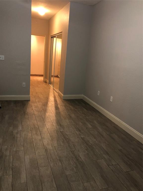 6928 Southwest 39th Street, Unit 207 Fort Lauderdale, FL 33314 - Photo 11 of 21 a view of an empty room with wooden floor and a window