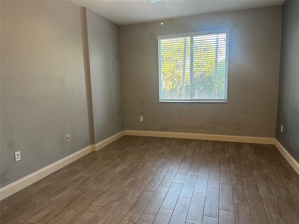 6928 Southwest 39th Street, Unit 207 Fort Lauderdale, FL 33314 - Photo 13 of 21 a view of an empty room with wooden floor and a window