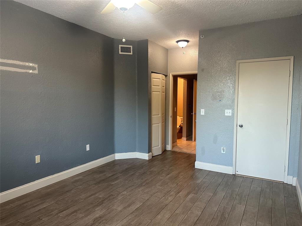 6928 Southwest 39th Street, Unit 207 Fort Lauderdale, FL 33314 - Photo 14 of 21 a view of an empty room with wooden floor and a window