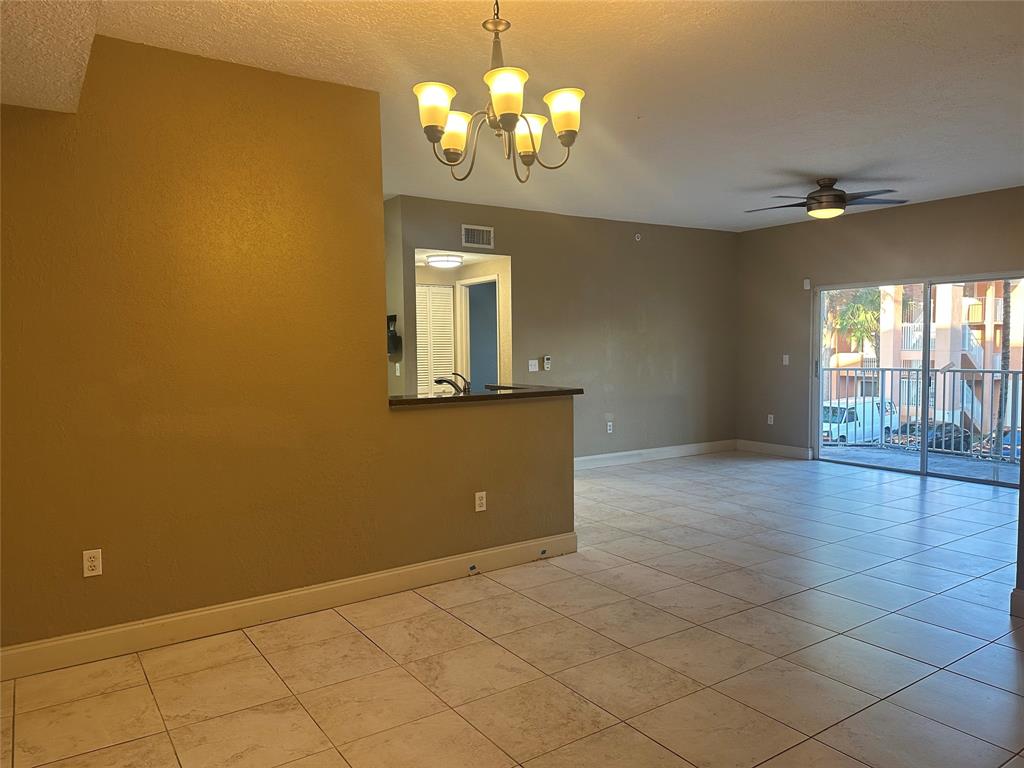 6928 Southwest 39th Street, Unit 207 Fort Lauderdale, FL 33314 - Photo 4 of 21 a view of a livingroom with a chandelier