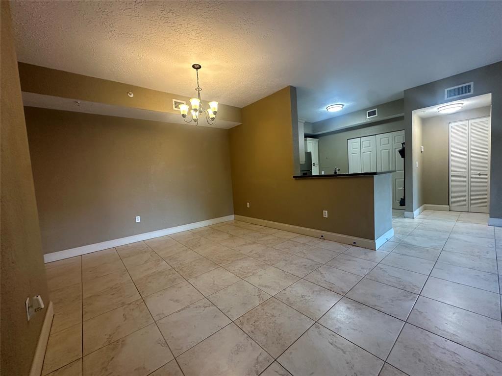 6928 Southwest 39th Street, Unit 207 Fort Lauderdale, FL 33314 - Photo 5 of 21 a view of a livingroom with a chandelier