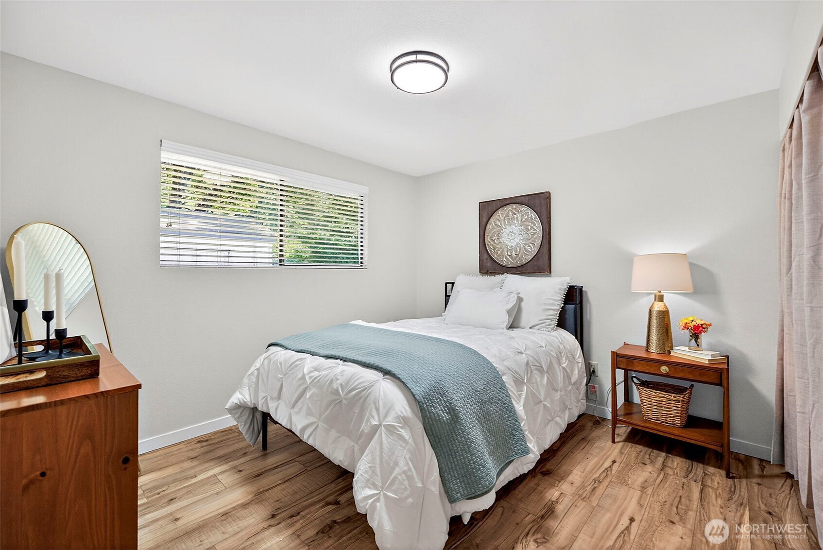 112 Lila Street Steilacoom, WA 98388 - Photo 17 of 37 a bed room with a bed and a chandelier