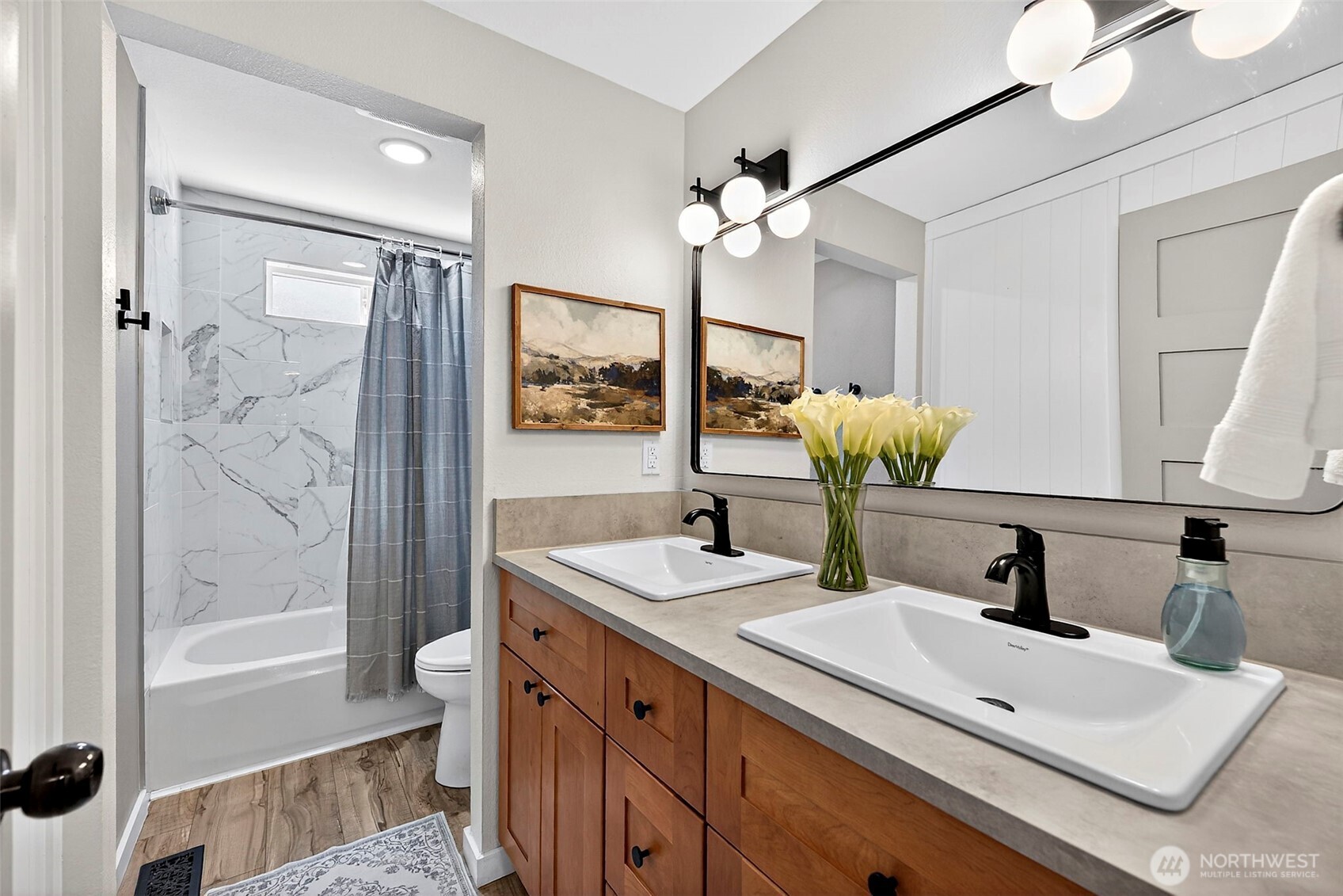 112 Lila Street Steilacoom, WA 98388 - Photo 18 of 37 a bathroom with a sink a toilet a mirror and shower