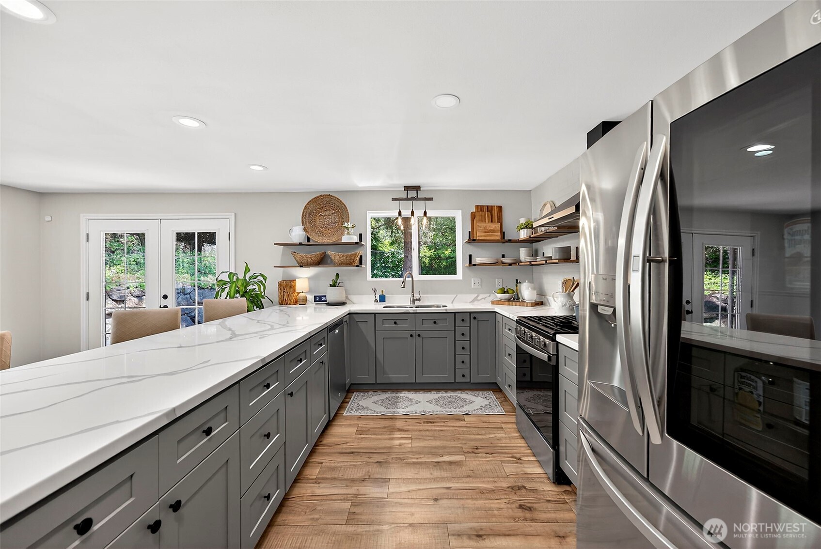 112 Lila Street Steilacoom, WA 98388 - Photo 21 of 37 a large kitchen with stainless steel appliances lots of counter space and windows