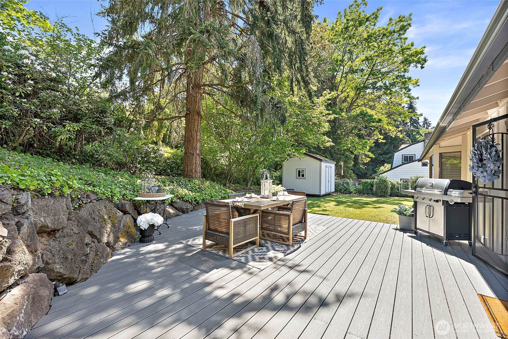 112 Lila Street Steilacoom, WA 98388 - Photo 27 of 37 a view of a patio with a dining table and chairs with wooden floor and fence