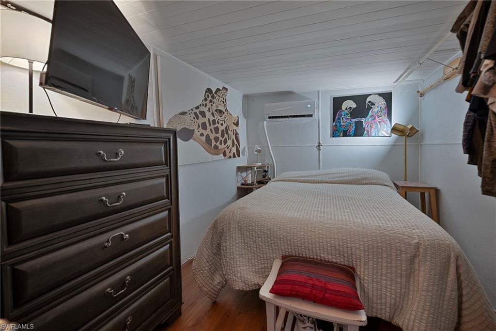 777 Walkerbilt Road, Unit 34 Naples, FL 34110 - Photo 13 of 22 a bed room with a bed and a window