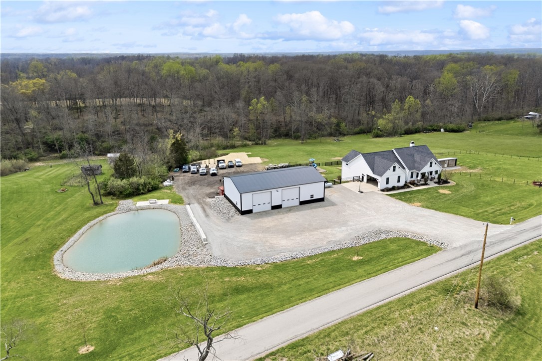 1158 Pyle Road Clarksville, OH 45113 - Photo 3 of 76 This expansive estate offers a charming home, shop, and a serene pond amidst lush greenery.