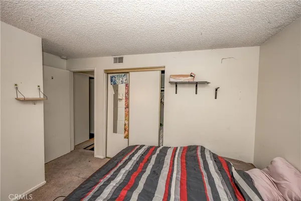 a bed sitting in a bedroom next to a window