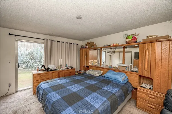 a bedroom with furniture and a large window