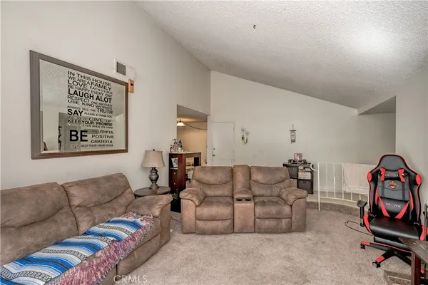 a living room with furniture a couch and dresser
