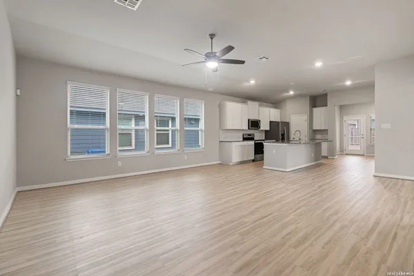 a view of large kitchen with wooden floor and windows
