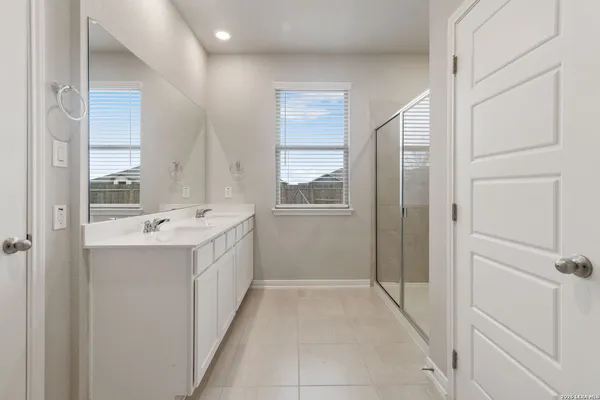 a bathroom with a sink a mirror and a shower