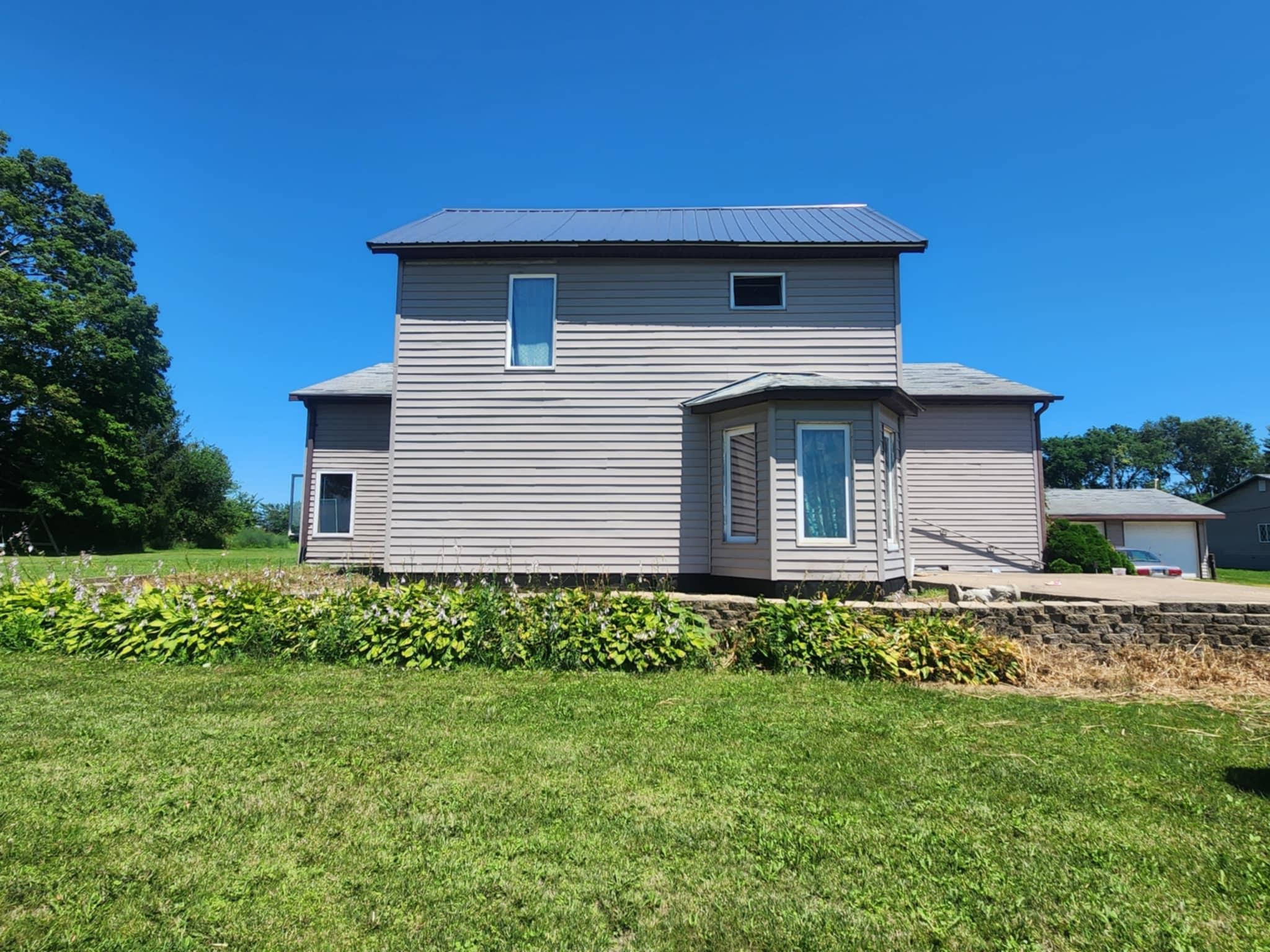 4592 West McConnell Road McConnell, IL 61050 - Photo 2 of 10 a front view of a house with garden