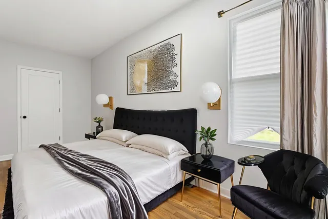 a bedroom with bed window and couch