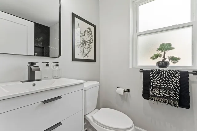 a bathroom with a sink toilet and mirror