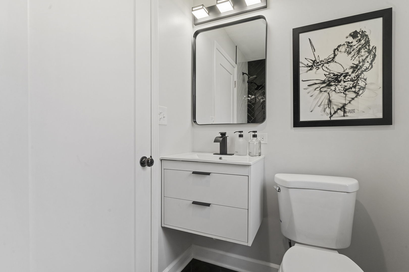 8746 South Wood Street Chicago, IL 60620 - Photo 14 of 27 a bathroom with a toilet sink and mirror