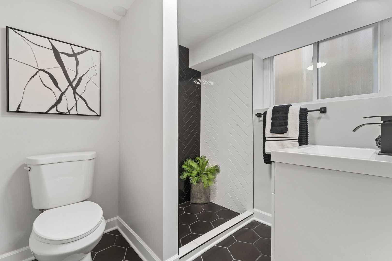 8746 South Wood Street Chicago, IL 60620 - Photo 21 of 27 a white toilet sitting next to a bathroom sink