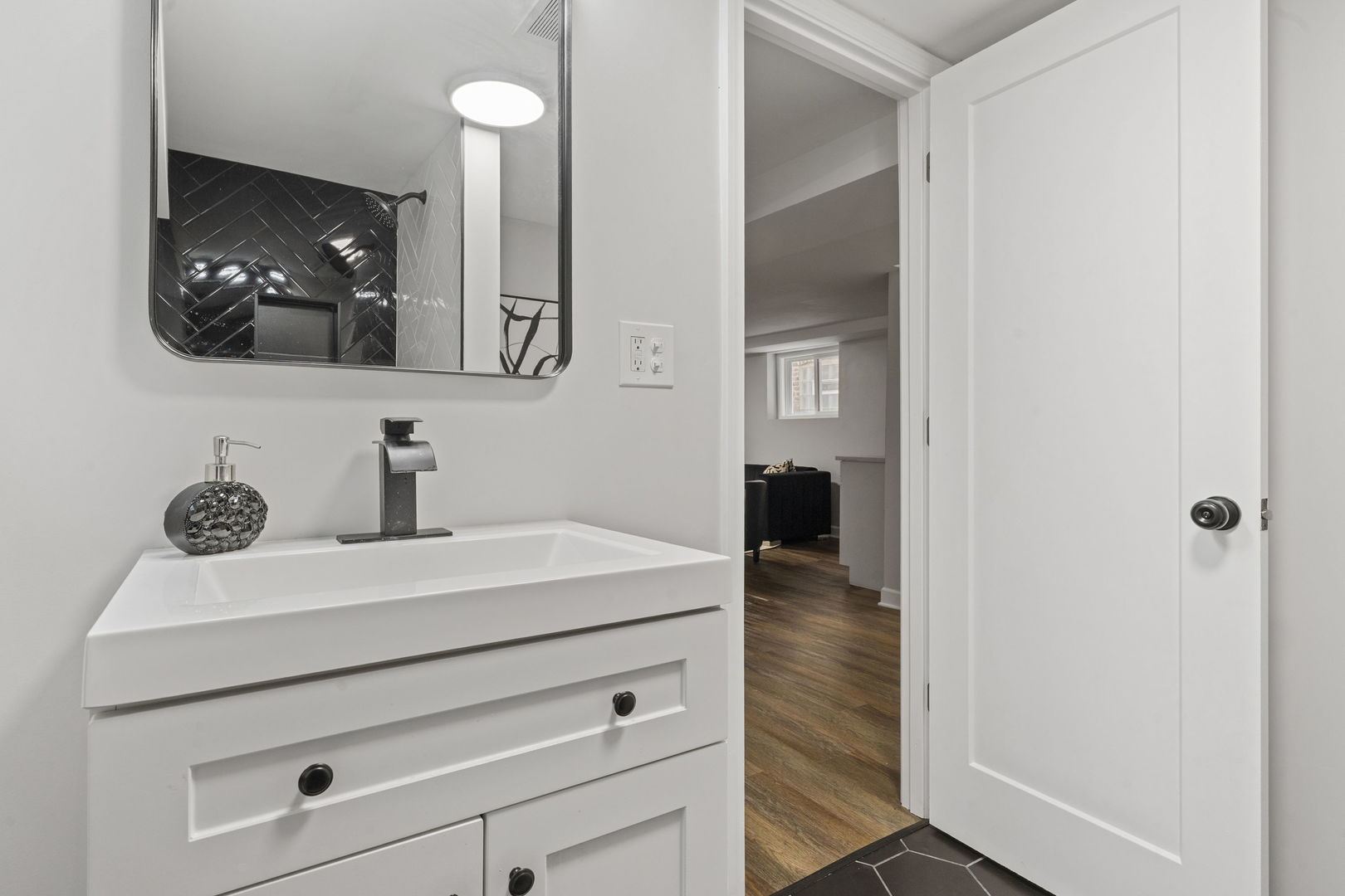 8746 South Wood Street Chicago, IL 60620 - Photo 22 of 27 a bathroom with a sink and a mirror