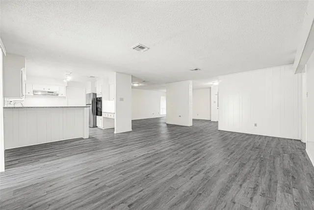 a view of a kitchen with wooden floor and a sink