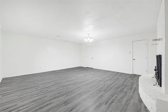 an empty room with wooden floor