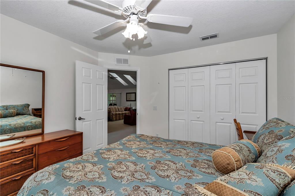 8342 Southwest 65th Avenue Ocala, FL 34476 - Photo 25 of 40 a bedroom with a large bed and a flat tv screen on dresser