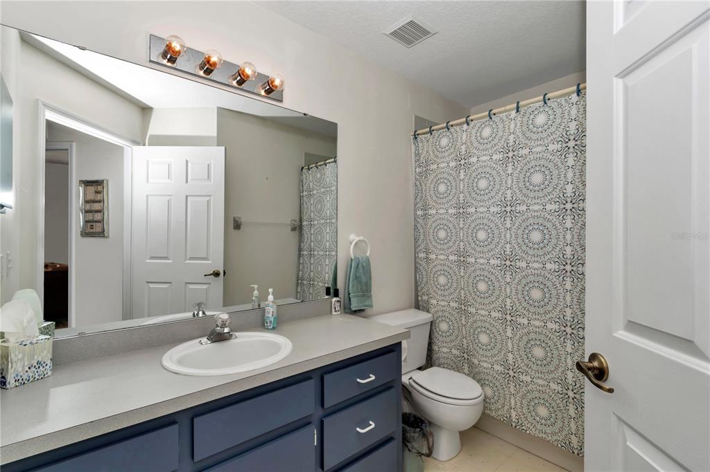 8342 Southwest 65th Avenue Ocala, FL 34476 - Photo 28 of 40 a bathroom with a double vanity sink toilet and a mirror