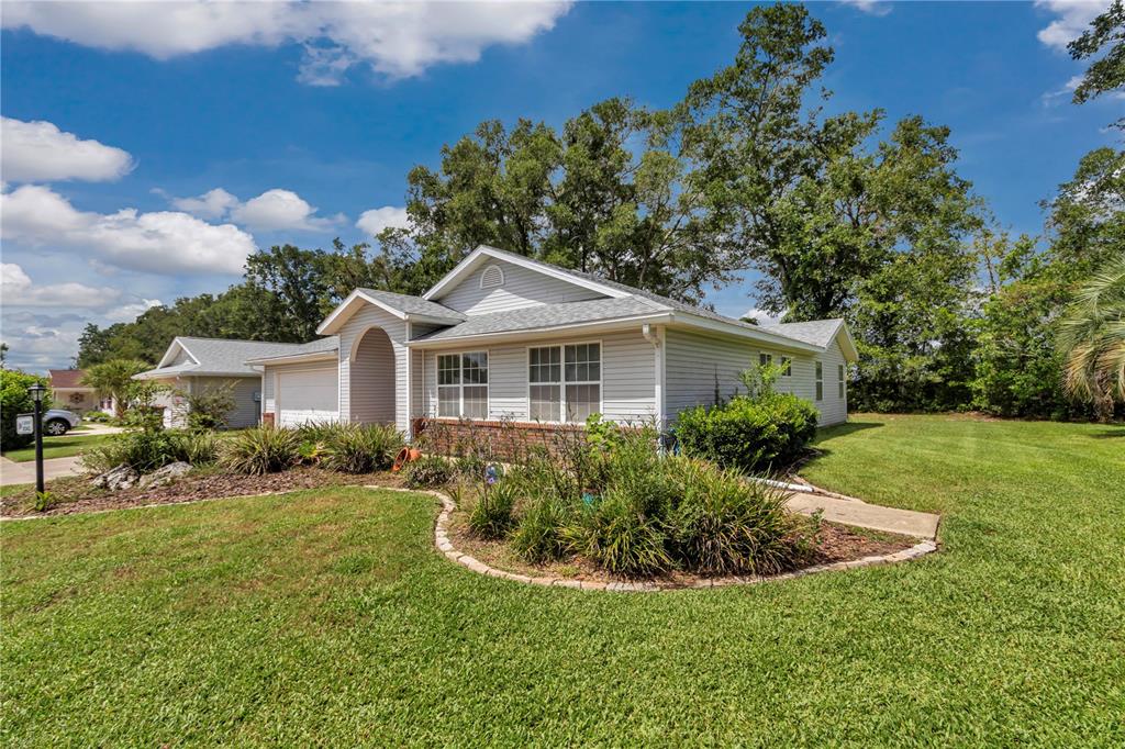 8342 Southwest 65th Avenue Ocala, FL 34476 - Photo 32 of 40 a view of a house with a yard and potted plants
