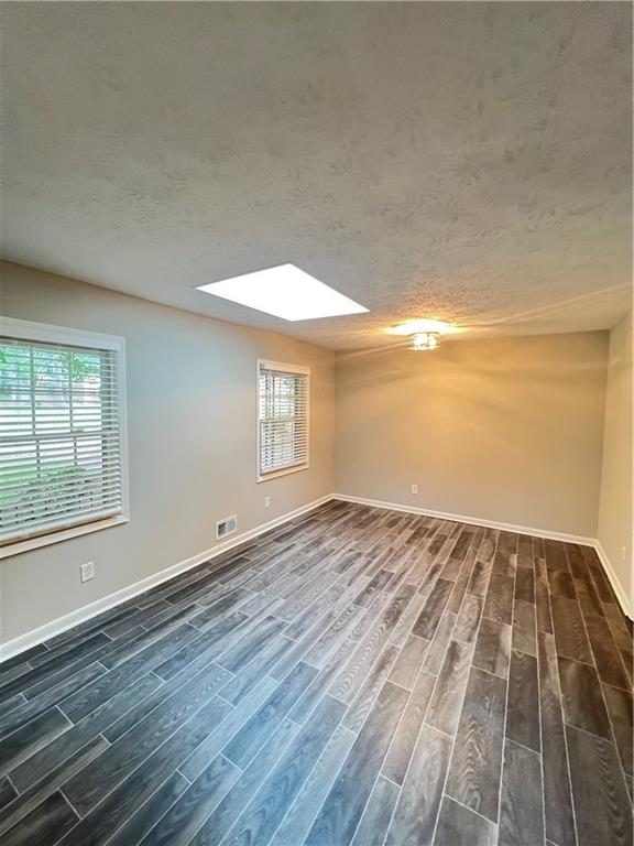 2838 The Meadows Way College Park, GA 30349 - Photo 3 of 10 wooden floor in an empty room with a window